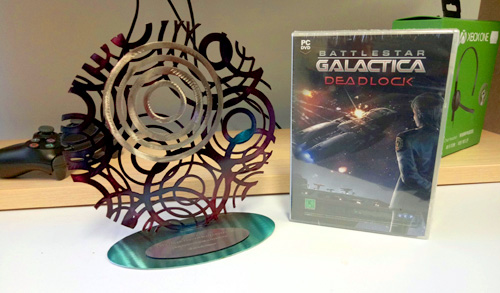 A photograph of a 2017 Australian Game Developer Award sits next to a PC copy of WA-made game Battlestar Galactica Deadlock