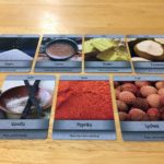 The final selection of game ingredient cards is laid out on the table. They are Sugar, Cocoa, Butter, Coconut, Vanilla, Paprika, and Lychee.